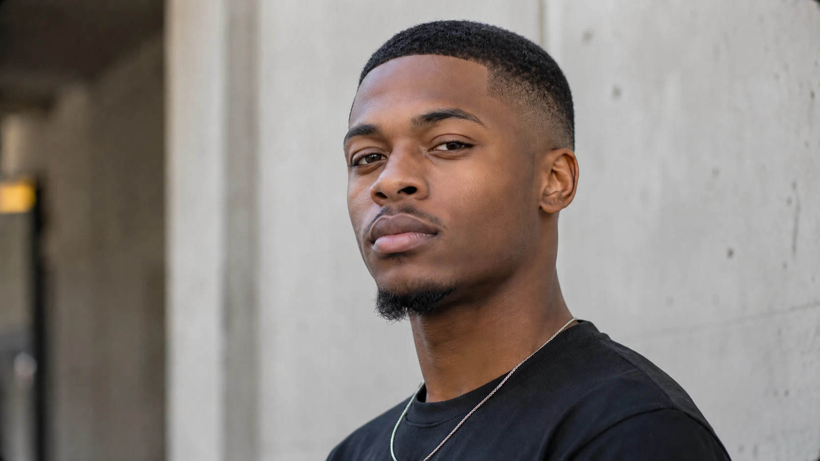 Before-and-after comparison of a portrait with wavy hair transformed into a close buzz cut. result