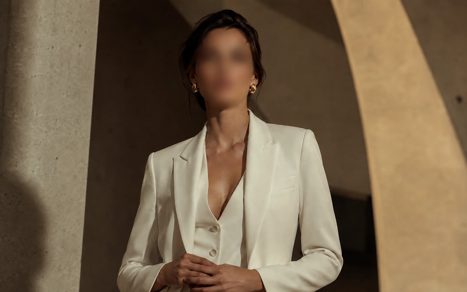 Before-and-after comparison of a formal portrait with the face blurred for privacy. result