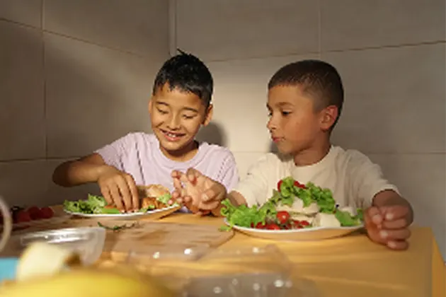 Before-and-after comparison of a family meal photo enlarged for clearer faces, table detail, and indoor scene texture.