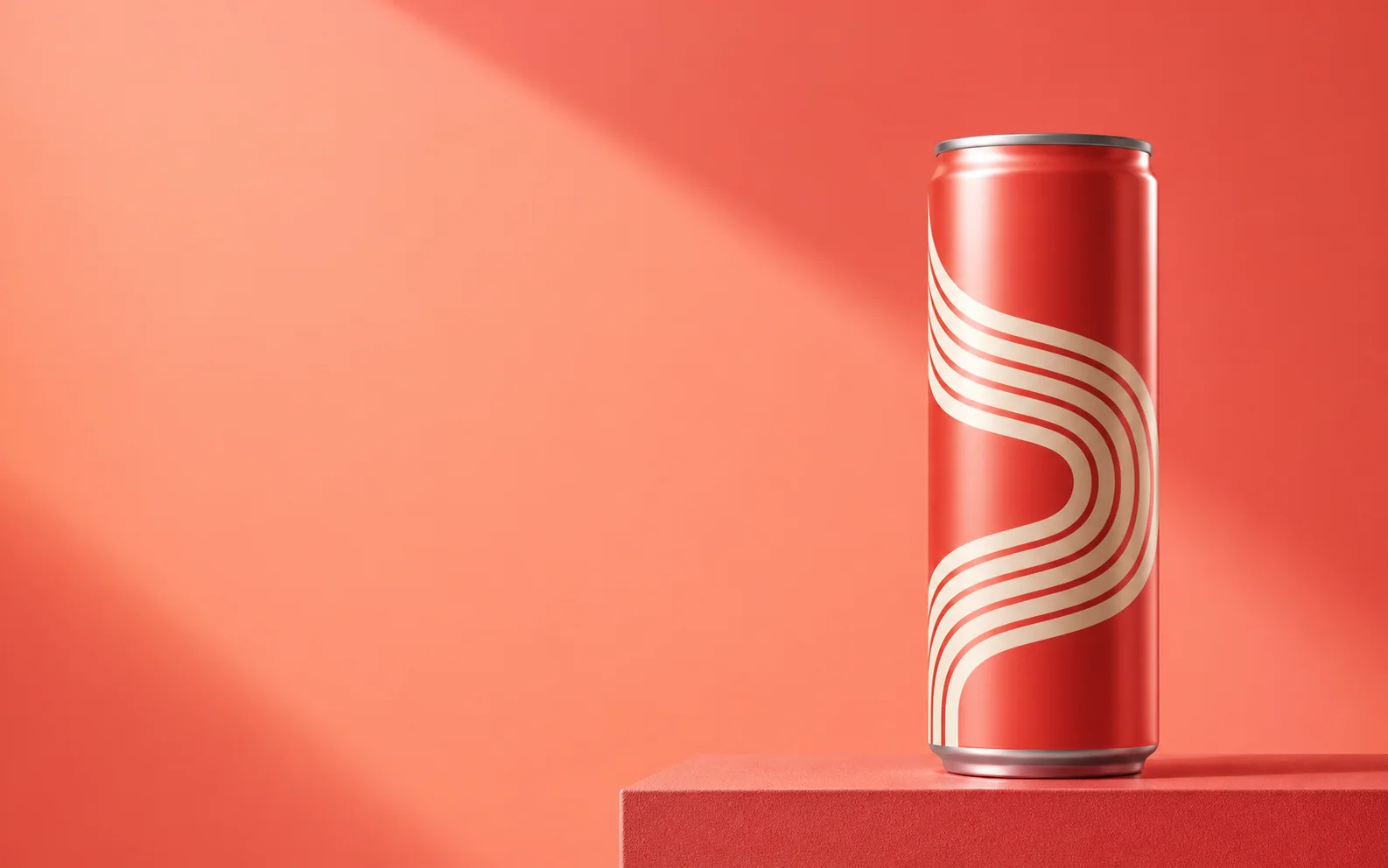Coral beverage can on the right with open space for advertising copy on the left.