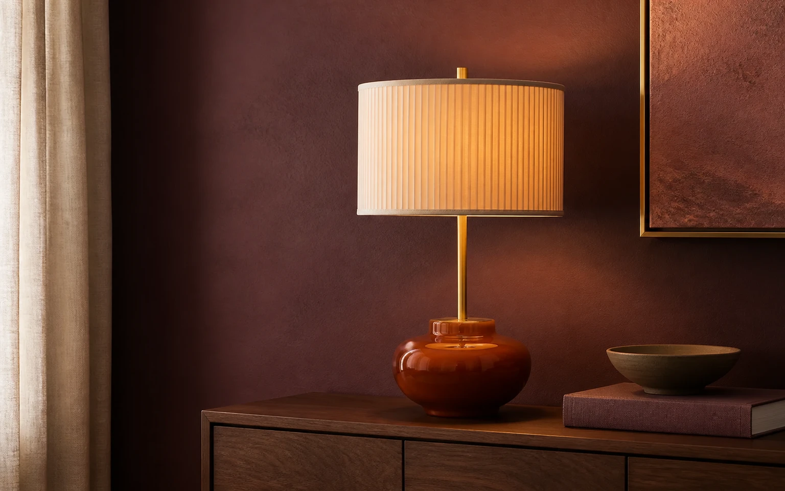Sculptural amber table lamp staged with a defined plum, rose, and brass visual system.