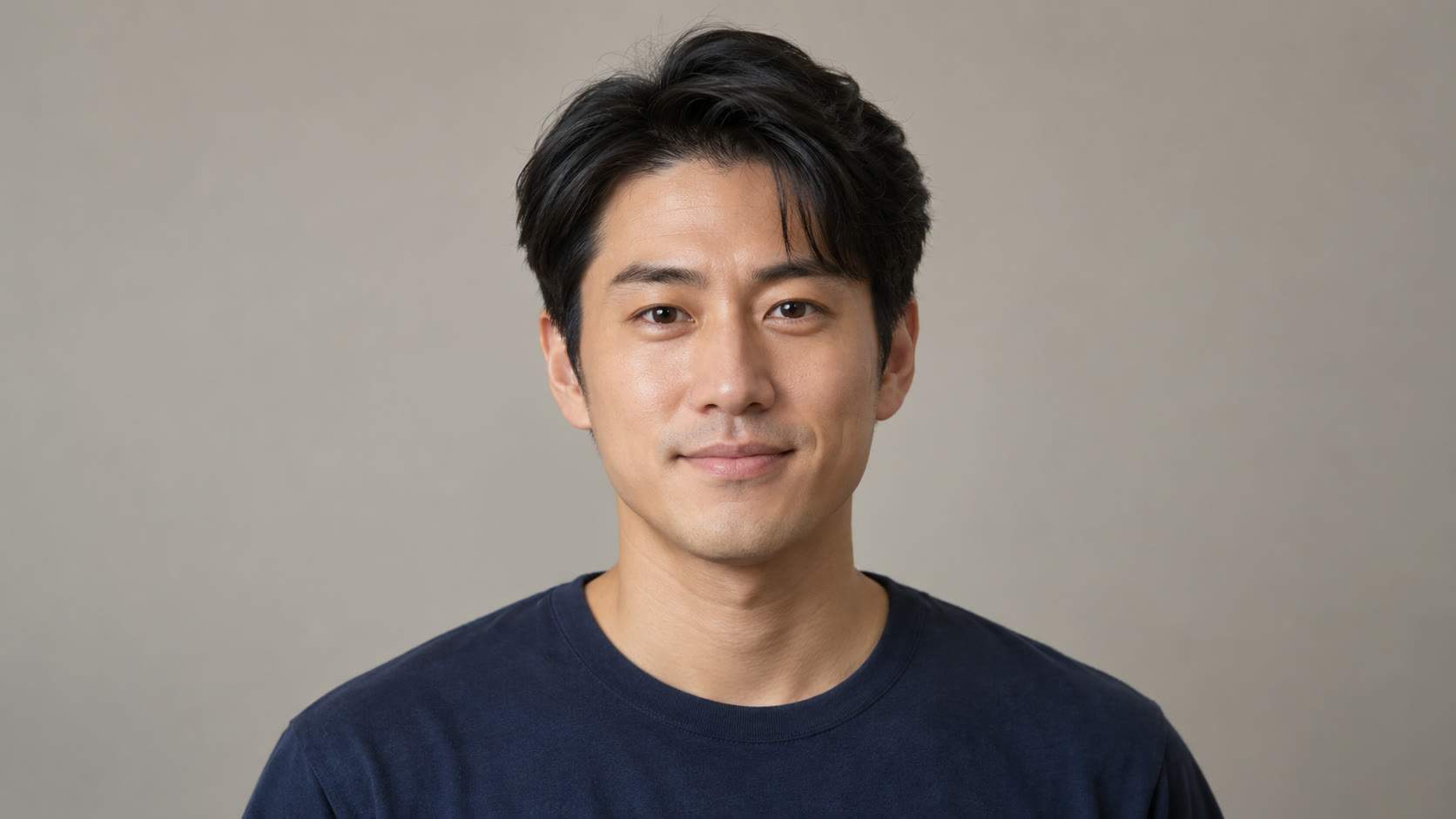 Man with dark hair in a navy shirt