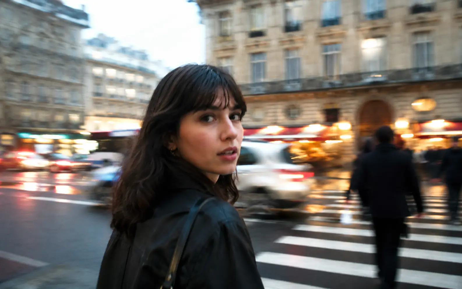 Before-and-after comparison of a handheld street portrait restored for clearer facial detail and edges.