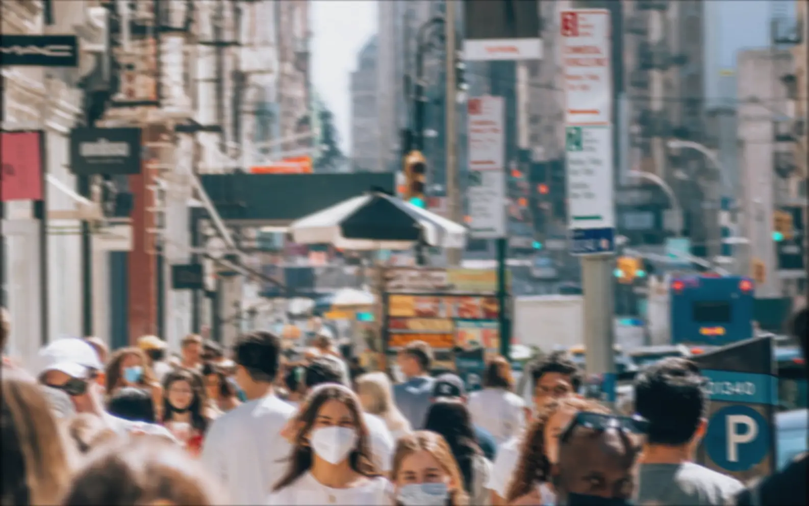 Before-and-after slider for a busy city scene, showing cleaner motion detail after AI deblurring.