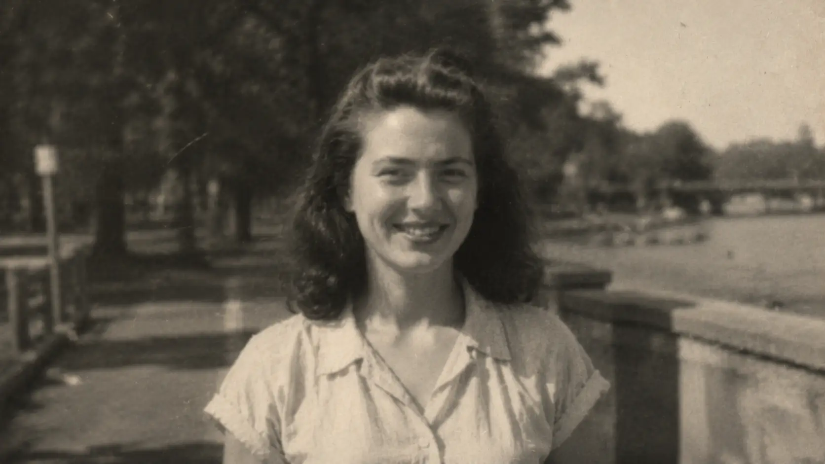 Before-and-after slider for a vintage portrait, showing a sharper face and cleaner film detail after upscaling.